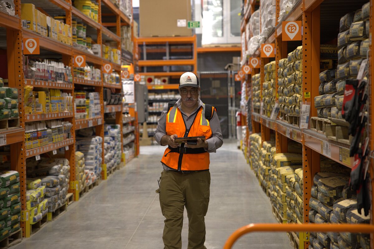 Joel Sadowsky conducting an NFPA 1225 grid-square signal survey inside a Texas warehouse — testing public-safety radio coverage bay by bay