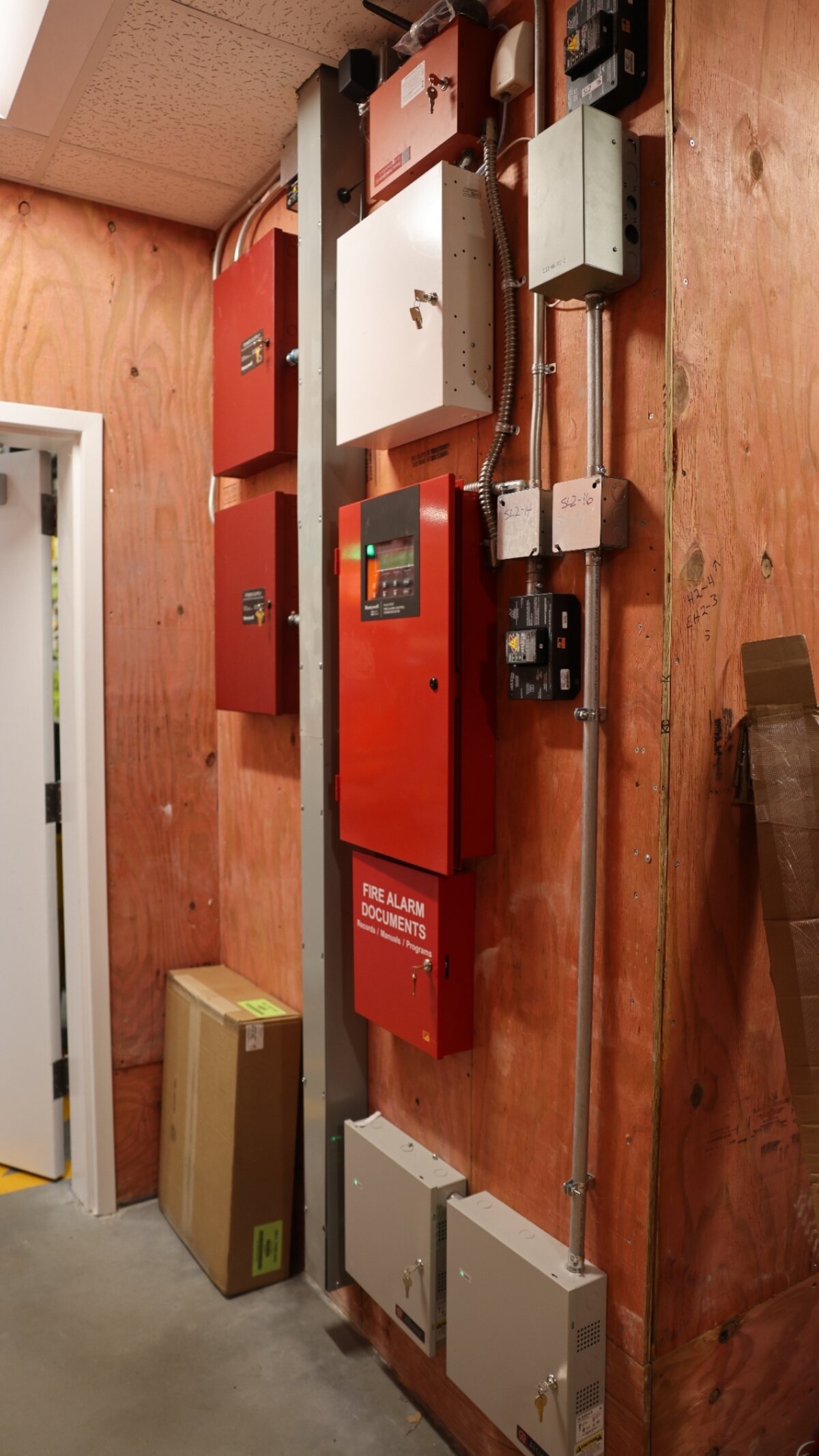 Fire alarm control room at a Texas commercial building — addressable FACP with dedicated power supply, backup batteries, and Zion service tag